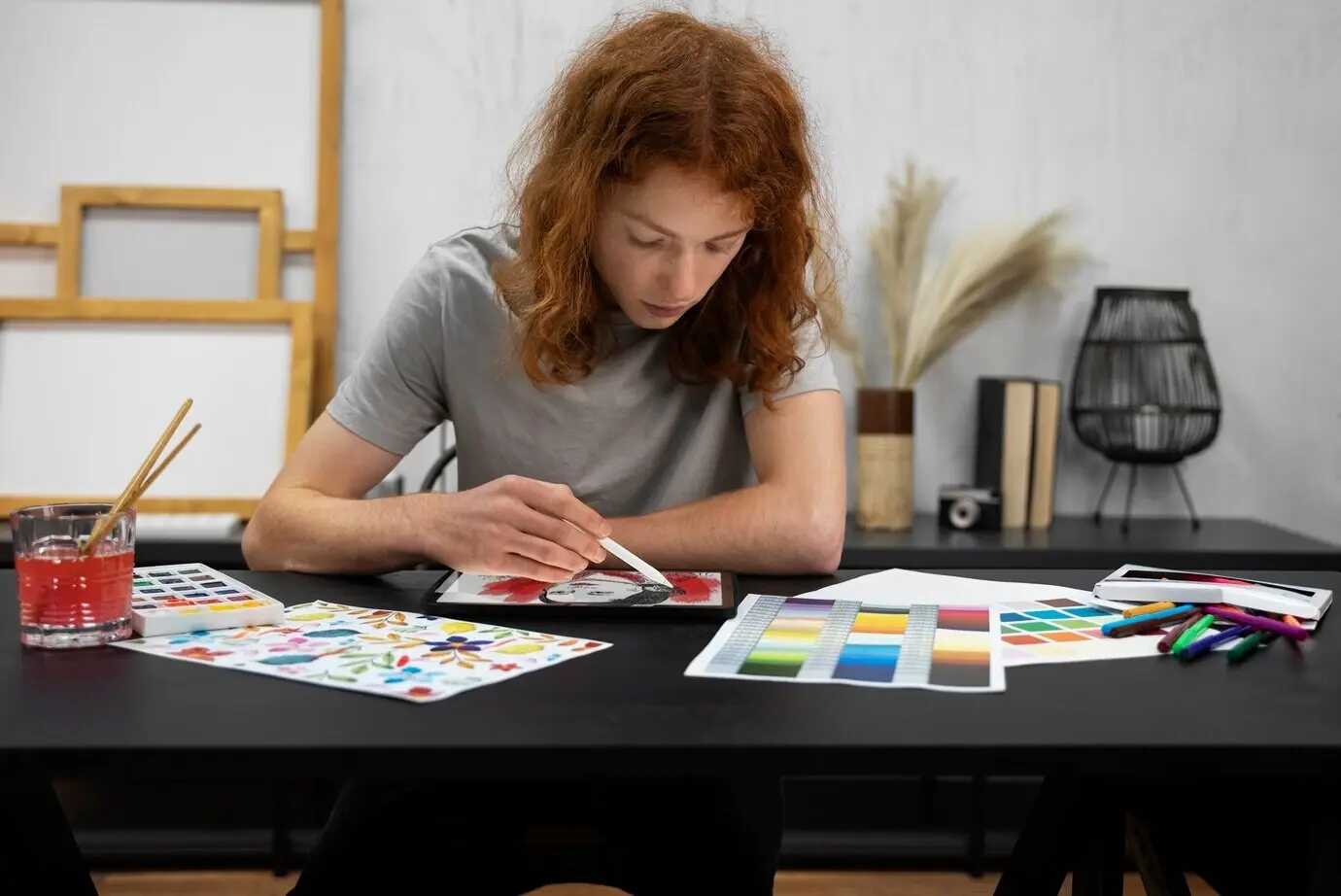Front view of a woman drawing on an iPad.