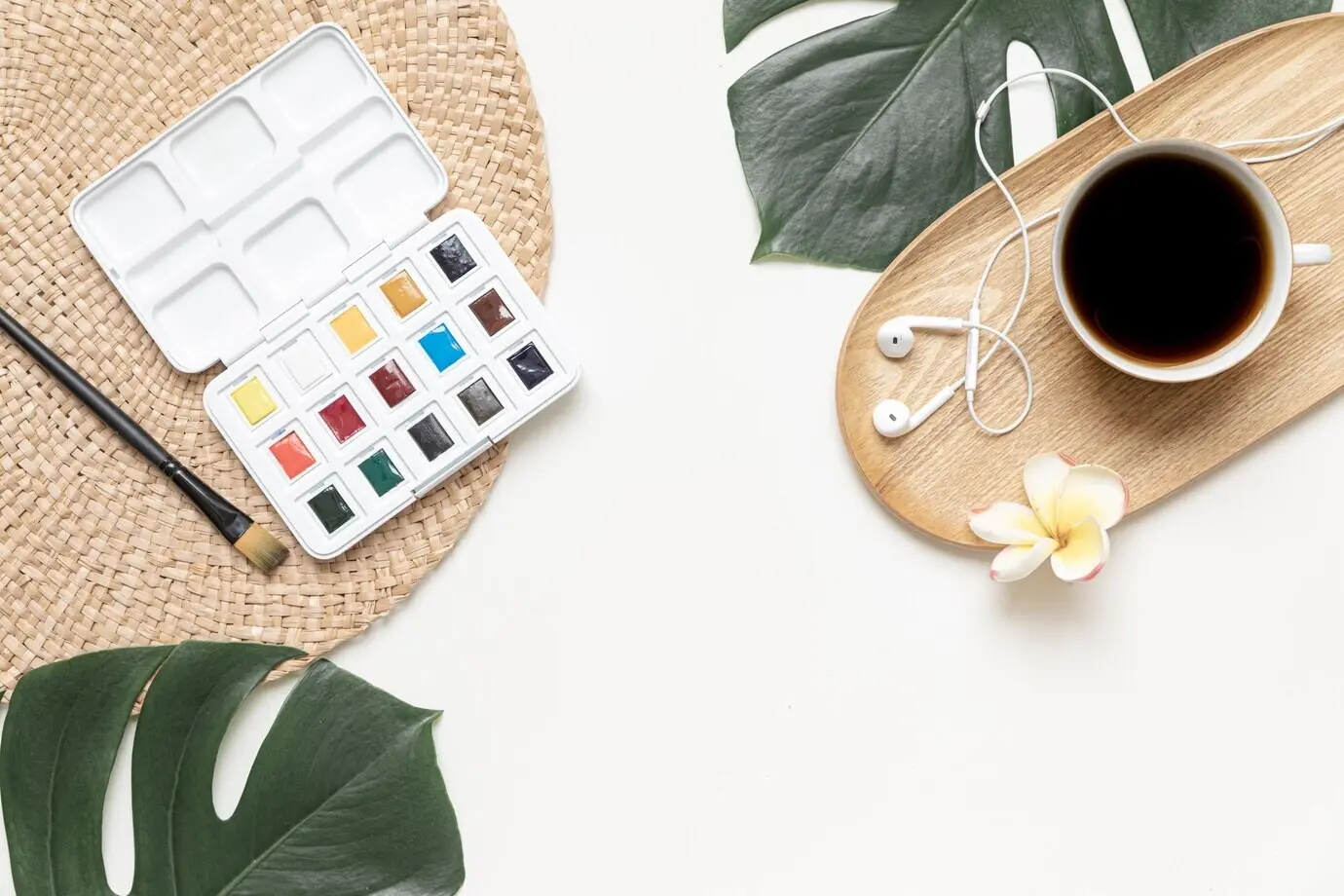 Overhead view of tropical leaves on a vivid background, summer flat lay composition.